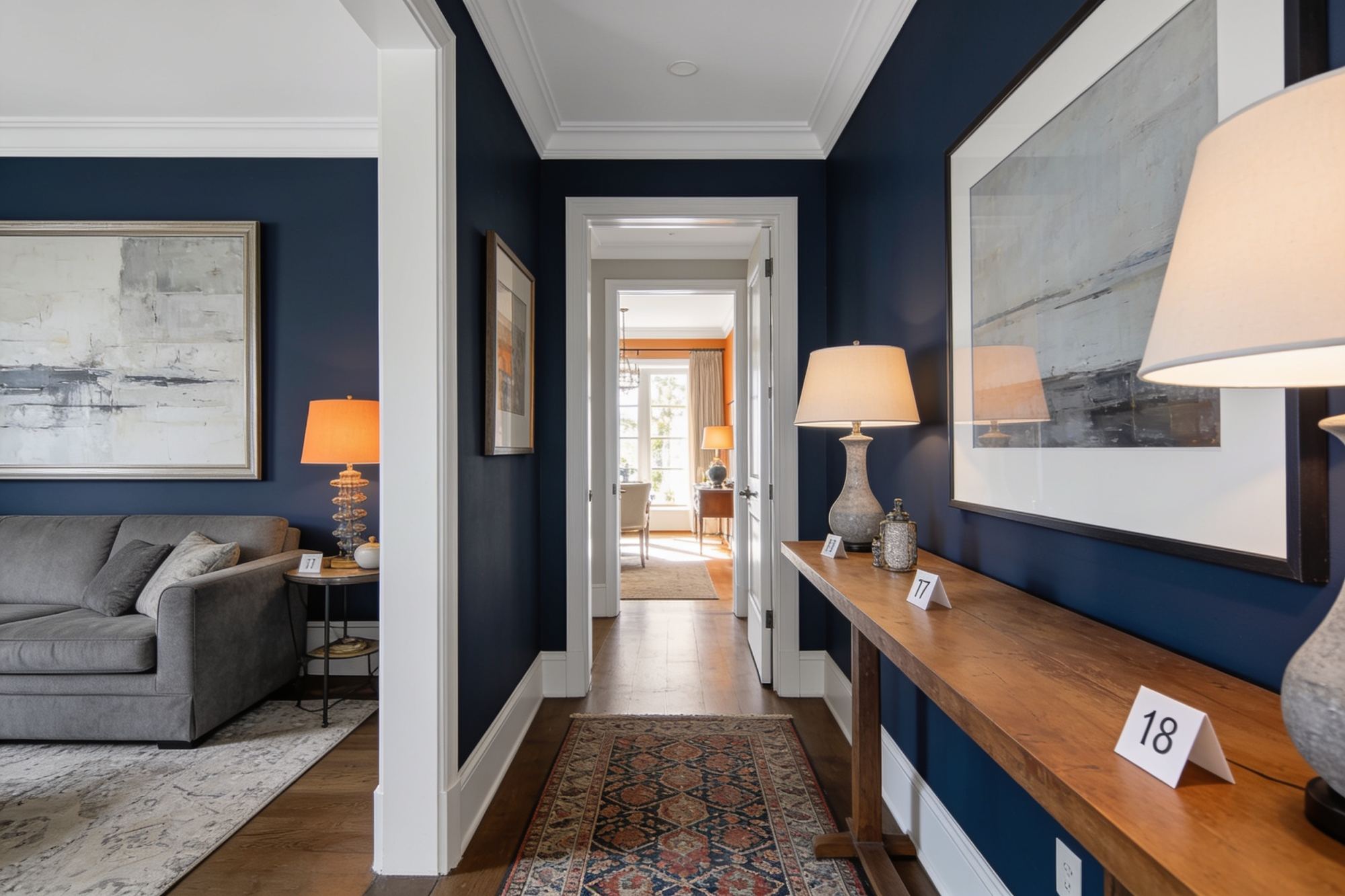 A richly furnished living room hallway staged for an estate sale, with price tags on the furniture